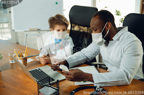 Image of Little caucasian boy as a doctor consulting for patient, working in cabinet, close up