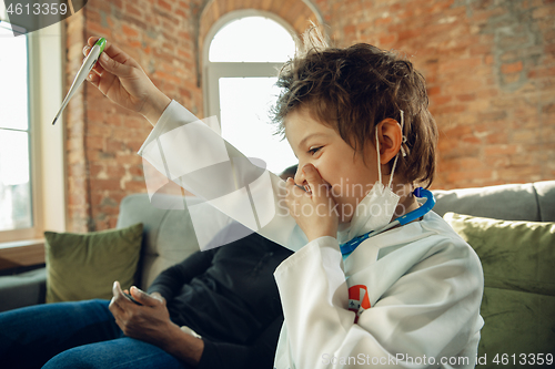 Image of Little caucasian boy as a doctor consulting for patient, working in cabinet, close up