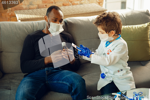 Image of Little caucasian boy as a doctor consulting for patient, working in cabinet, close up