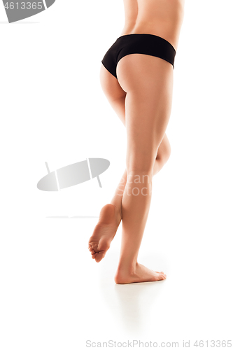 Image of Beautiful female legs and butt isolated on white background. Beauty, cosmetics, spa, depilation, treatment and fitness concept, sensual posing