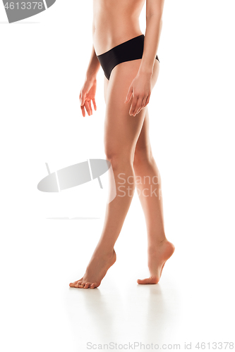 Image of Beautiful female legs isolated on white background. Beauty, cosmetics, spa, depilation, treatment and fitness concept, sensual posing