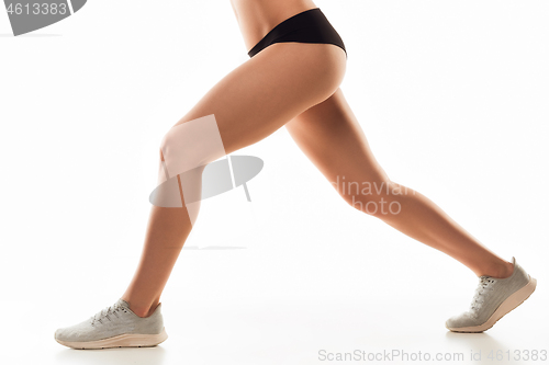 Image of Beautiful female legs and butt isolated on white background. Beauty, cosmetics, spa, depilation, treatment and fitness concept, sensual posing