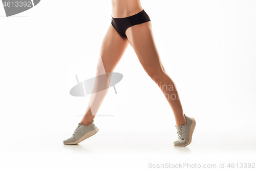 Image of Beautiful female legs and butt isolated on white background. Beauty, cosmetics, spa, depilation, treatment and fitness concept, sensual posing