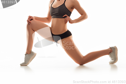 Image of Beautiful female legs and butt isolated on white background. Beauty, cosmetics, spa, depilation, treatment and fitness concept, sensual posing