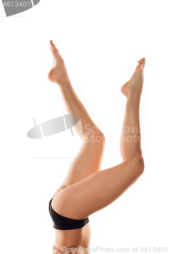 Image of Beautiful female legs isolated on white background. Beauty, cosmetics, spa, depilation, treatment and fitness concept, sensual posing