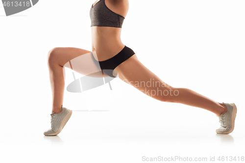 Image of Beautiful female legs and butt isolated on white background. Beauty, cosmetics, spa, depilation, treatment and fitness concept, sensual posing