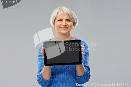 Image of senior woman using tablet computer