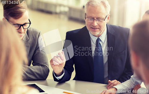 Image of architects with tablet pc and blueprint at office