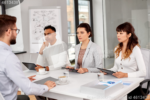 Image of recruiters having job interview with male employee