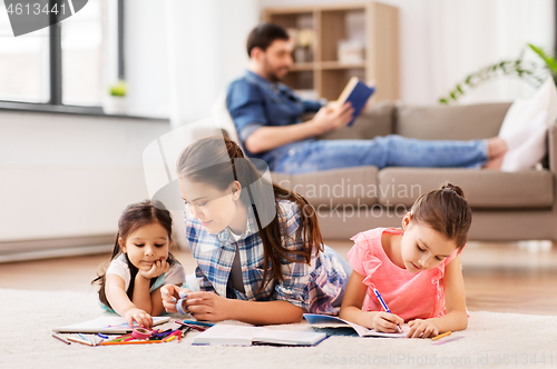 Image of mother with little daughters drawing at home