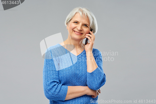 Image of smiling senior woman calling on smartphone