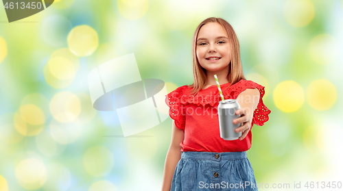 Image of smiling preteen girl drinking soda from can