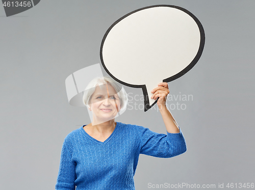 Image of smiling senior woman holding big speech bubble