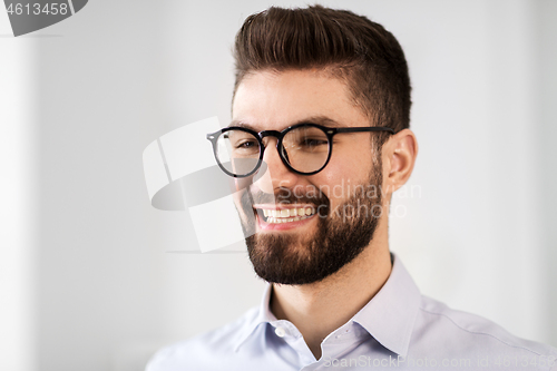 Image of portrait of smiling bearded businessman in glasses