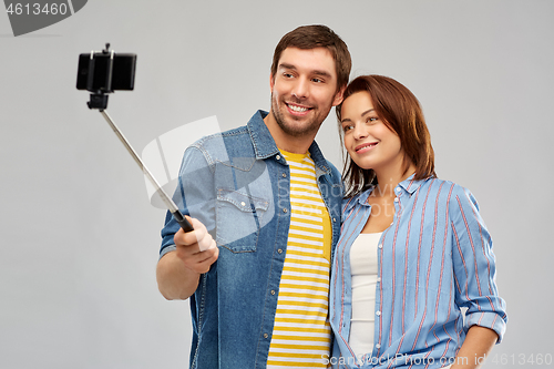 Image of happy couple taking selfie by smartphone