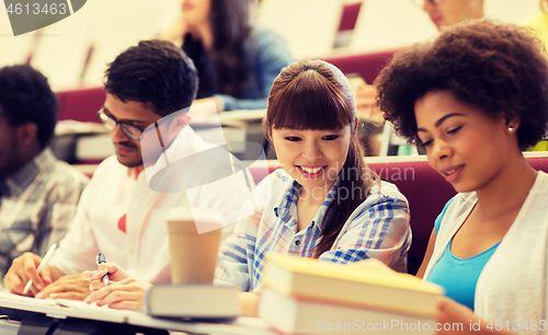 Image of group of international students talking on lecture