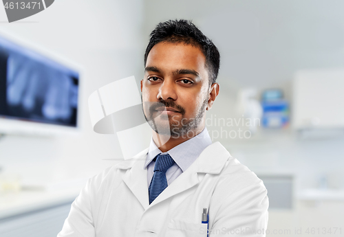 Image of indian dentist in white coat at dental clinic