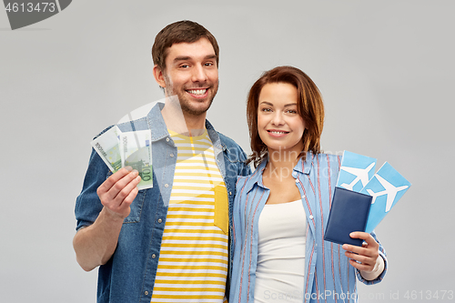 Image of couple with air tickets, passport and money