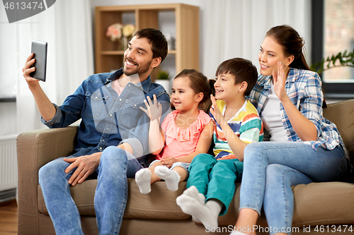 Image of happy family having video call on tablet computer