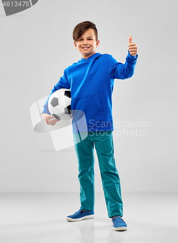 Image of smiling boy with soccer ball showing thumbs up