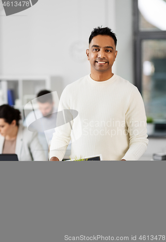 Image of happy male office worker with personal stuff