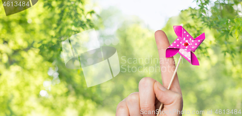 Image of close up of hand holding pinwheel toy