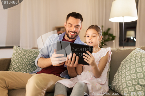 Image of father and daughter with tablet computer at home