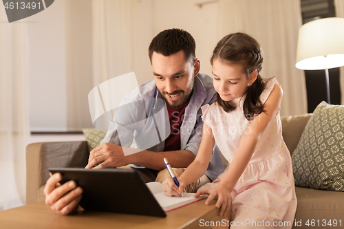 Image of father and daughter doing homework together