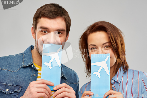 Image of happy couple with air tickets