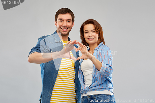 Image of happy couple making hand heart