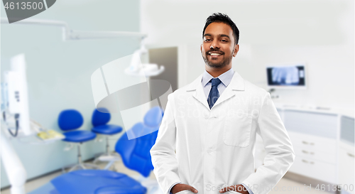 Image of indian male dentist in white coat at dental clinic