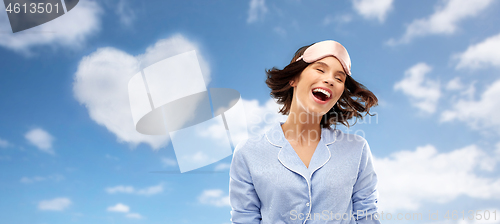 Image of happy young woman in pajama and eye sleeping mask