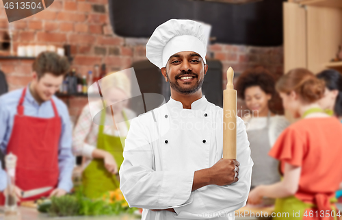 Image of male indian chef with rolling-pin at cooking class