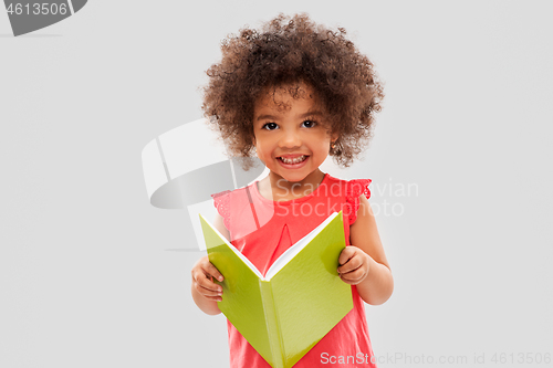 Image of happy little african american girl reading book