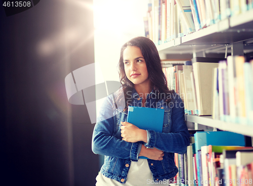 Image of high school student girl with book at library