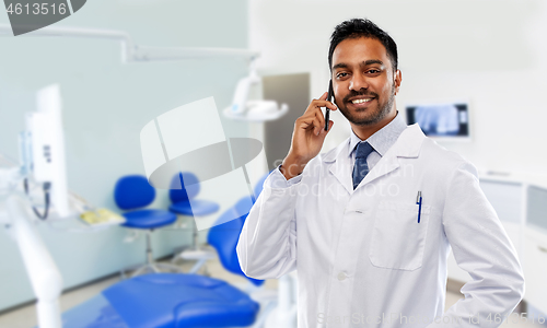 Image of dentist calling on smartphone at dental clinic