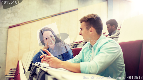 Image of group of students with notebooks at lecture hall