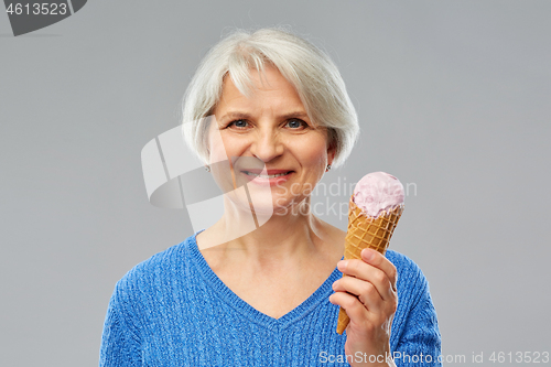 Image of portrait of smiling senior woman with ice cream