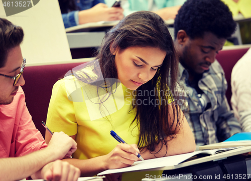 Image of group of international students writing at lecture