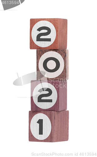 Image of Four isolated hardwood toy blocks, saying 2021