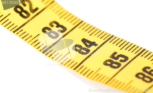 Image of Close-up of a yellow measuring tape isolated on white - 84