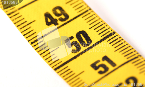 Image of Close-up of a yellow measuring tape isolated on white - 50