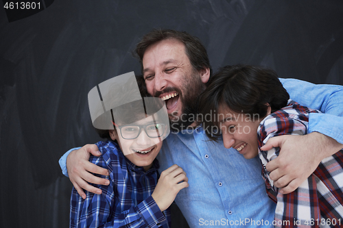 Image of happy father hugging sons