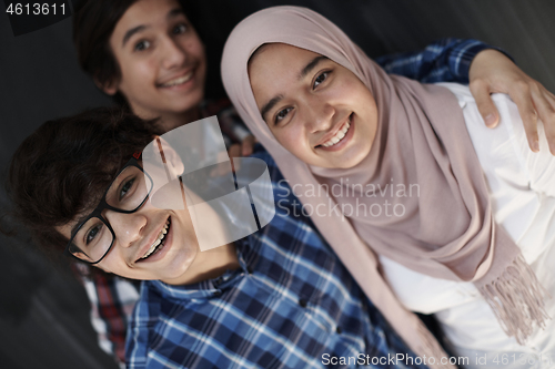 Image of group of arab teens taking selfie photo on smart phone