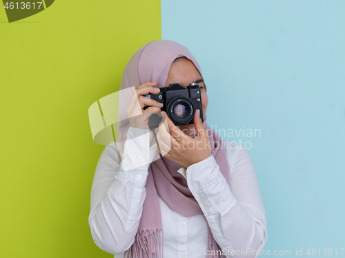 Image of Arab young woman photographer with  camera