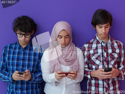 Image of arab teenagers group using smart phones online education