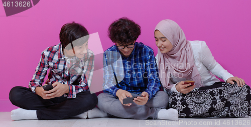 Image of arab teenagers group using smart phones online education