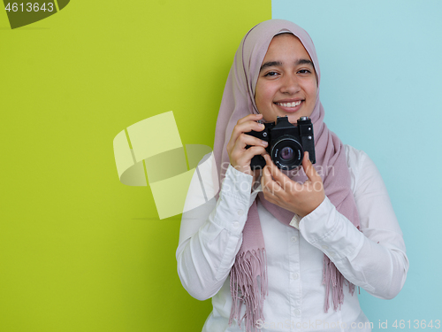 Image of Arab young woman photographer with  camera