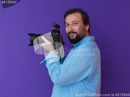 Image of Portrait of  male Photographer purple background