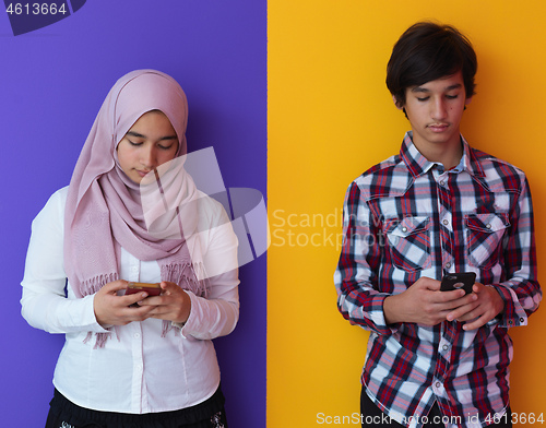 Image of arab teenagers group using smart phones online education